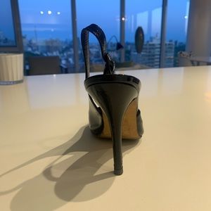 Manolo Blahnik luxury black patent leather sling backs.